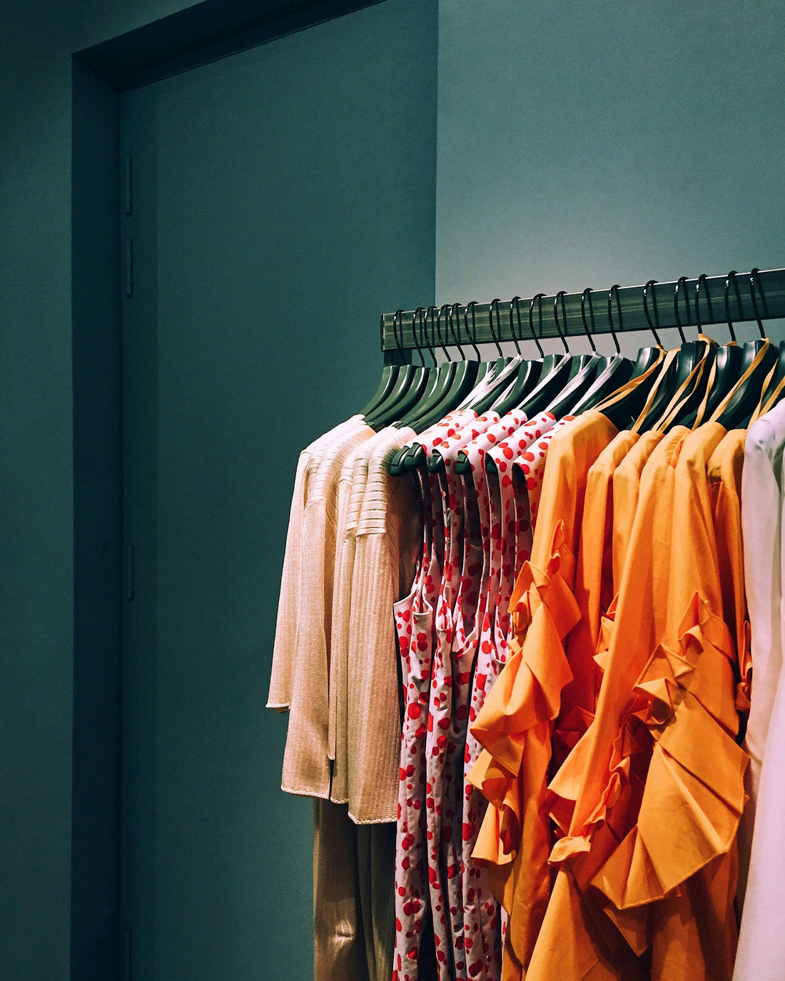 Clothing displayed on a retail rack, illustrating online fashion business and branding